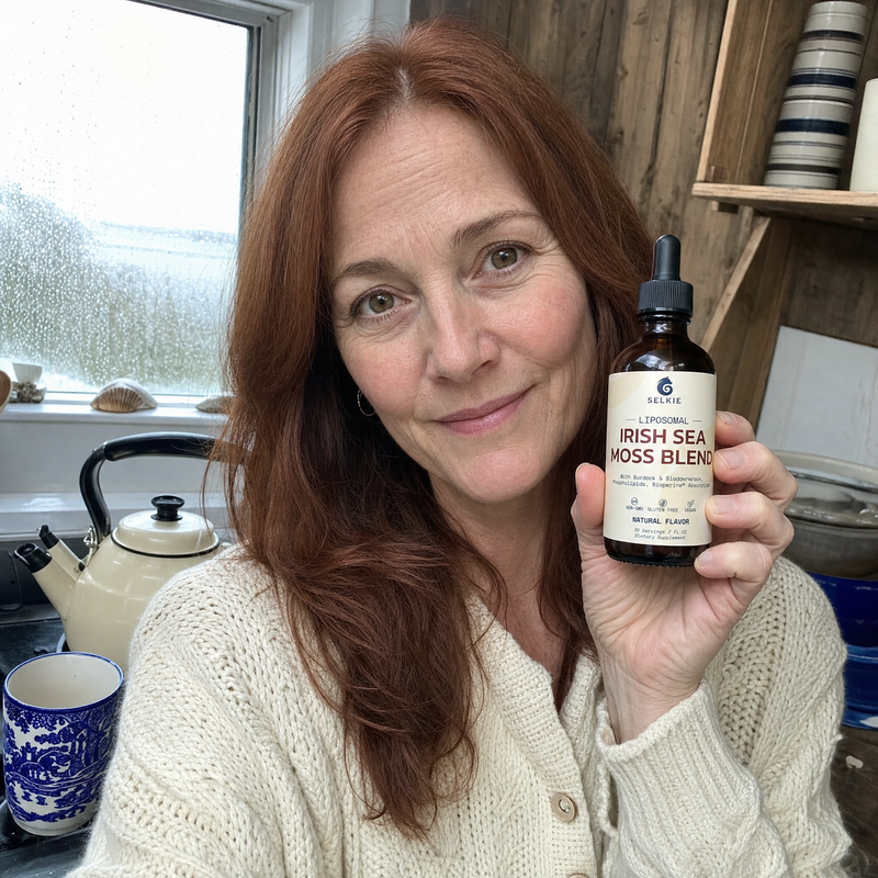 Woman holding Selkie Irish sea moss dropper in a real kitchen